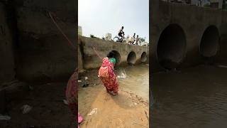 A woman catches fish from a large dam with a hook  amazing fishing in the canal  fishing shorts [upl. by Ennaira]