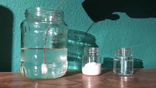 Nucleation point being introduced to a supersaturated solution of sodium acetate in water [upl. by Cottrell]