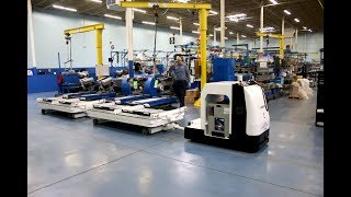 Dematic Compact Tugger AGVs at AER Manufacturing [upl. by Eylrac]