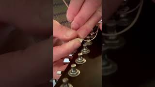 How to properly restring a guitar Go around the pole 2 times before going through the hole [upl. by Saunders]