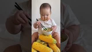 Baby sitting on a pile of corn eating noodles [upl. by Akenna727]