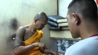 A devotee gets an oil sak yant on his forehead in Wat Bang Phra  Thailand [upl. by Romelda]