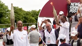 WATCH Snoop Dogg carries Olympic torch ahead of 2024 Opening Ceremony [upl. by Colene]