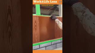 The worker uses a wood graining tool to mimic wood grain on a painted exterior wall [upl. by Dosia]