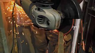 angle grinder with abrasive cutting disc is cutting steel pipe after in dark garage [upl. by Schroder]