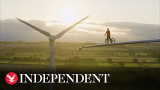 Procyclist attempts stunt on blade of wind turbine ahead of Cop26 [upl. by Akahc]