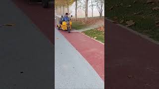 The process of clearing fallen leaves on sidewalks with high pressure water guns [upl. by Plantagenet]