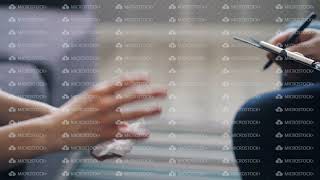 Close up of female hands holding tissue and psychologist writing notes in office [upl. by Eornom]