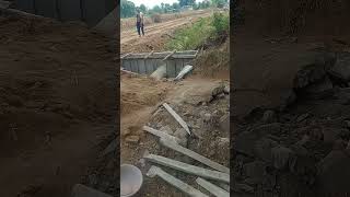 Construction site headwall of pipe culvert on canal [upl. by Eatnwahs]