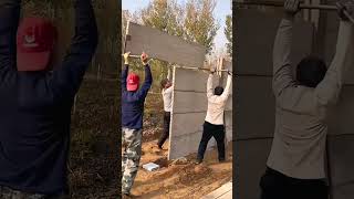 Construction workers assembling cement prefabricated panels into a wallEasy to useHigh efficiency [upl. by Inod390]