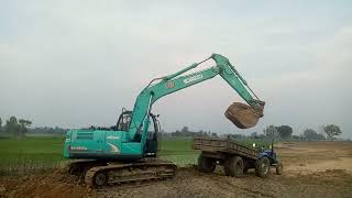 Big Excavator purple kobelco sk 250HD loading tractor mining soil [upl. by Arondell]