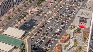 Aerial view of many colorful cars parked on parking lot with lines and markings for parking places [upl. by Harriott]