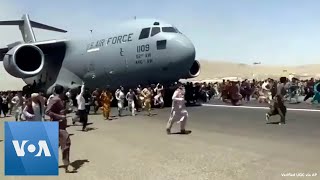 Afghans Try to Flee at Kabul Airport [upl. by Eanyl]