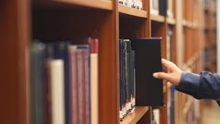 Man Picking Books in Library 01  Free Stock Footage 4K [upl. by Nagey]