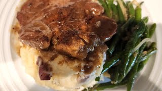 Pan seared pork chops smothered in onion gravy mashed potatoes and green beans [upl. by Annohsal]