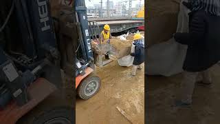 A forklift loads sand into a bag [upl. by Wulf899]