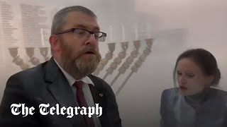 Polish MP uses fire extinguisher to snuff out Jewish menora in parliament [upl. by Adnalram]