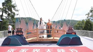 Celebrations held for Qixi Festival on glass bridge in Chinas Zhangjiajie [upl. by Auhsuoj]