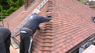 Reroofing my your house Cementing the bonnet tiles wwwgarecoukroof [upl. by Essej]