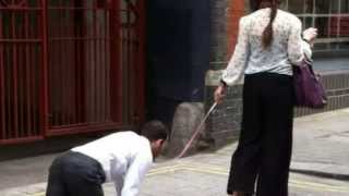 Bizarre scene as woman spotted taking man for walkies on dog lead in London street [upl. by Ilac591]