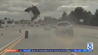 Runaway tire sends car flying into the air [upl. by Ahsaeit]