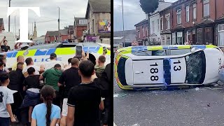 Leeds riot moment crowd overturns police car [upl. by Adnalohs]