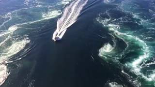 Boat cruising through Saltstraumen maelstrom near Bodø Norway [upl. by Clywd351]